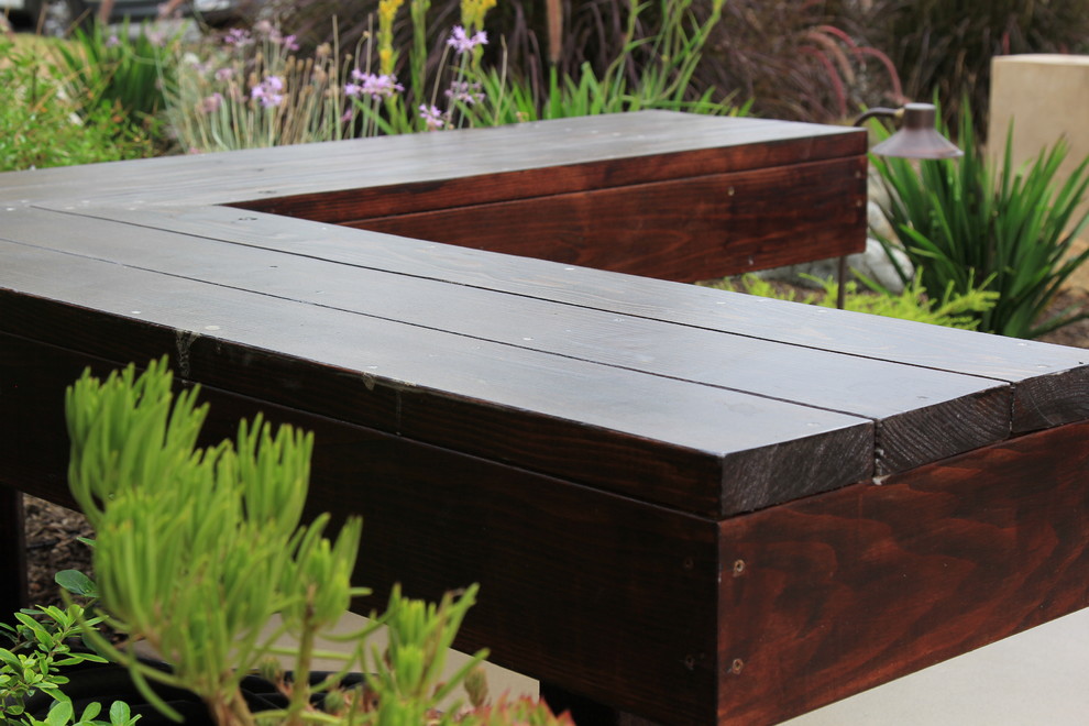 Contemporary wood bench with dark stain.